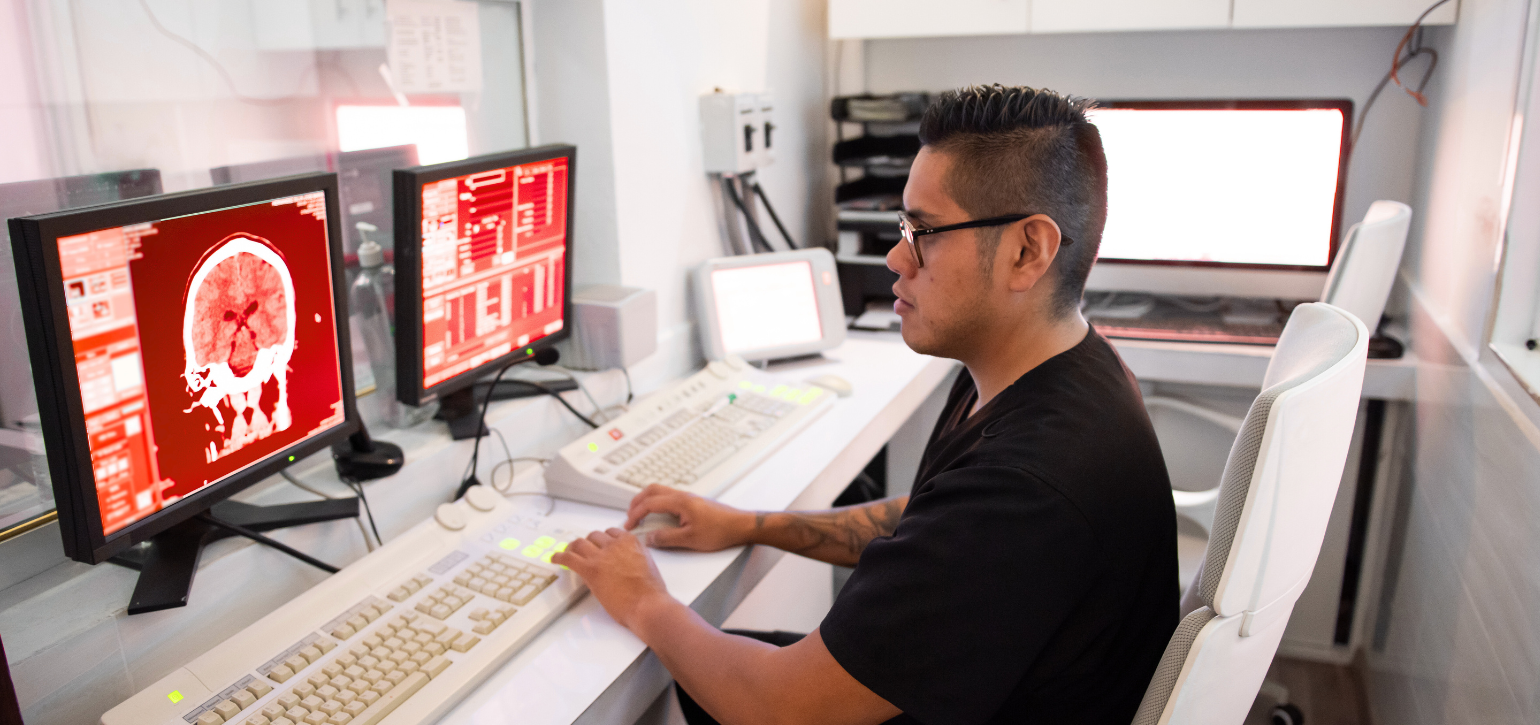 Asian man at bank of computers